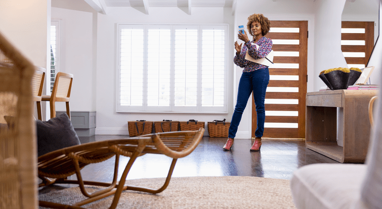 woman taking photos of home