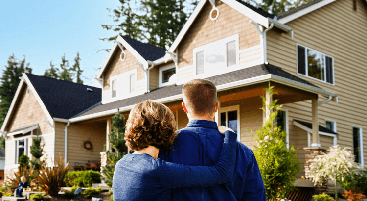 Homebuyers in front of their dream home