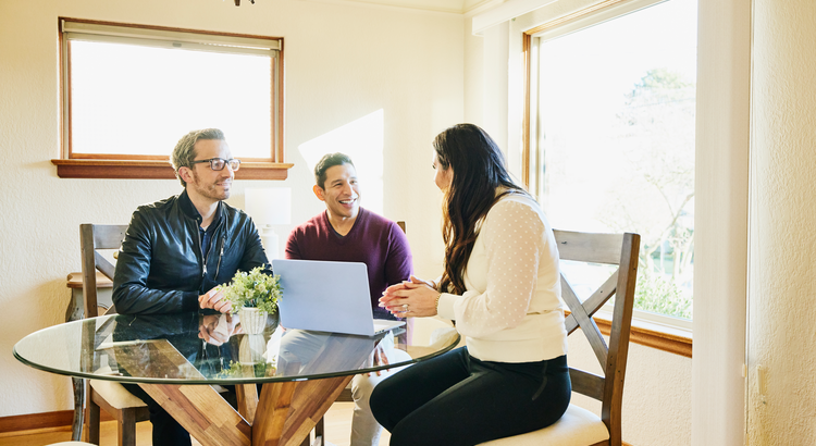 Agent sitting at table with two sellers