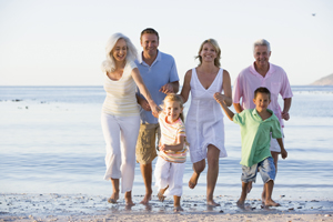 Extended family walking on beach